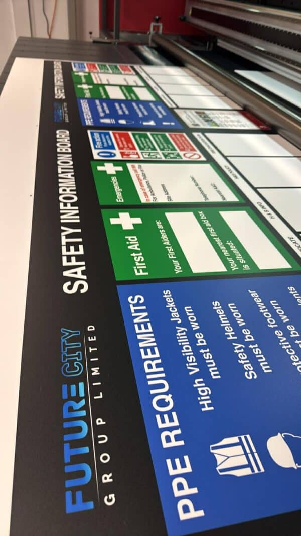Large safety information board with PPE requirements and safety guidelines.