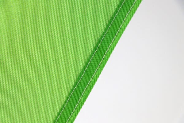 Close-up of green teardrop flag fabric for outdoor advertising.
