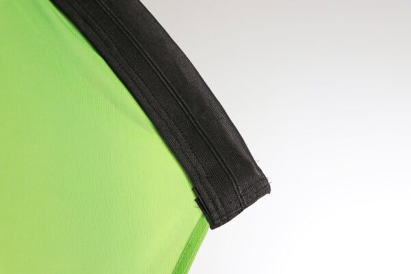 Close-up of a green teardrop flag with black pole edge for outdoor advertising.