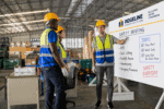 Construction workers in safety gear during safety briefing at Big Value Banners.