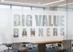 Big Value Banners logo on frosted glass office partition.
